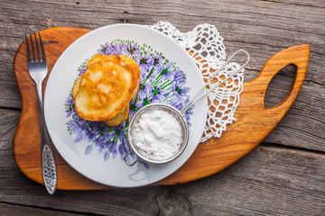 Stack of pancakes with jam and sugar