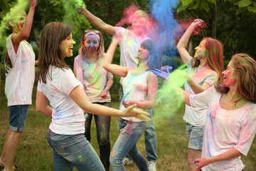 Young people celebrate Holi color festival in park