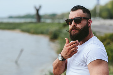 American Bearded Man touching his beard © teksomolika