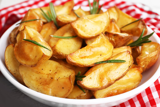 Baked potato wedges on table, closeup