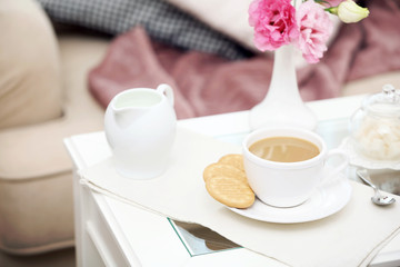 Cup of coffee on table in living room