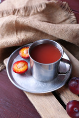 Delicious plum juice with fruits on table close up