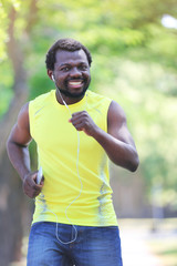 African American young man jogging in park