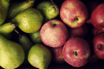 Red apples and green pears close up