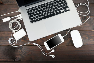 Computer peripherals and laptop accessories on wooden background