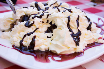 Traditional Hungarion dessert with whipped cream and chocolate sauce called somloi