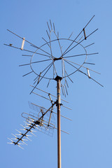 Unusual shaped television antenna against a blue sky