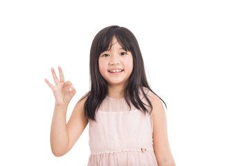 Obraz na płótnie Canvas beautiful little asian girl showing OK gesture isolated on white background