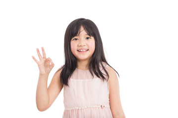 beautiful little asian girl showing OK gesture isolated on white background