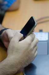 Close up of a man using mobile smart phone