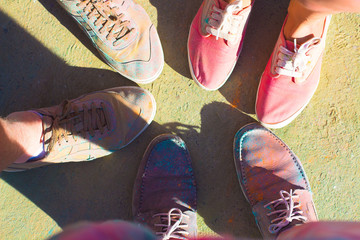 Friends put their feet as a sign of unity and teamwork. Holi fes