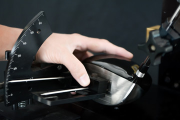 Club Maker checking the loft angle of golf club