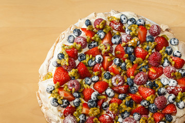 Pavlova dessert on wooden table