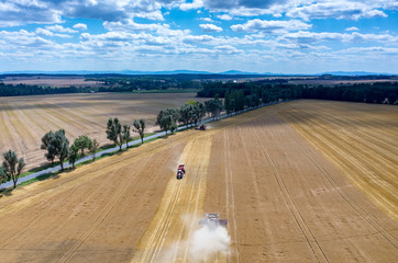 Combines and tractors working on the wheat field