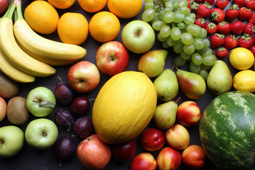 Fresh mixed fruits background on kitchen table