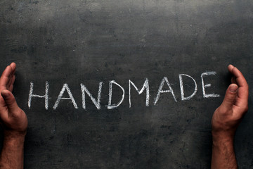 Handmade title on chalkboard with hands