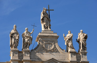 Fototapeta na wymiar Jesus blessing statue between saints, popes and apostles at the top of Archbasilica of St. John Lateran in Rome