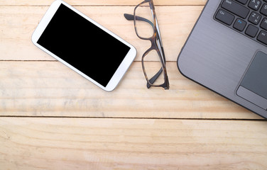 Office workplace with laptop and smart phone on wood table