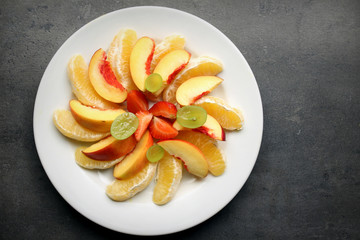Fresh fruit pieaces on white plate