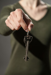 Unrecognizable woman offering a keys