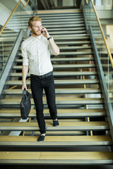 Fototapeta na wymiar Young businessman on the stairs