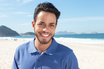 Lachender Mann mit Bart am Strand