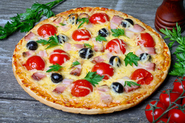 pizza with bacon, olives and tomato