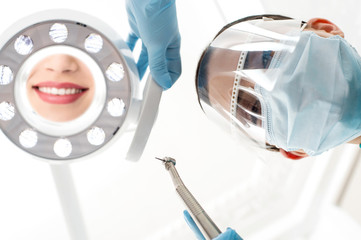 Dentist preparing dental mirror for working