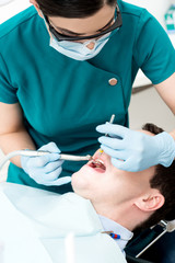 Dentist examines a patient