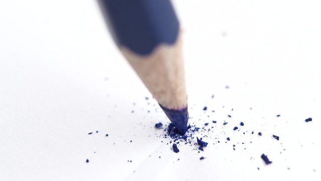 Broken head of sharp blue pencil on a white, slow motion