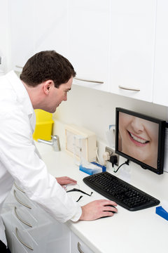 Dentist examining in monitor