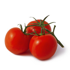 three fresh tomatoes with green leaves isolated on white background