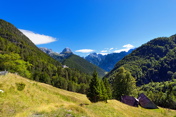 Fototapeta na wymiar Peak of Mangart and Jalovec - Slovenia / Peak of Mount Mangart (2679 m), and peak of Mount Jalovec 2645 m. (Gialuz). In the Triglav National Park, Slovenia, Europe