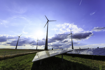 wind turbines and modern solar panels in the country side
