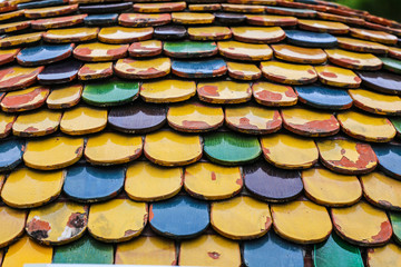 Colorful worn out round tiles with yellow green and blue colors