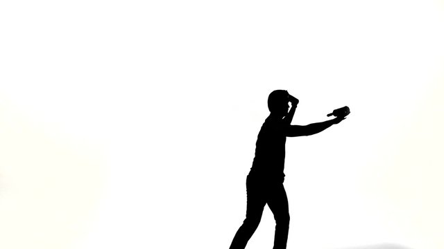 silhouette of barman man showing tricks with a bottle 