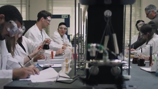 Students working on their science experiments - Powered by Adobe