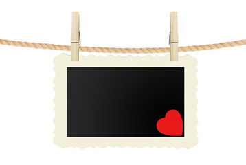 photo card with red heart hanging on rope isolated on white