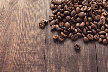 Roasted coffee beans on the wooden background
