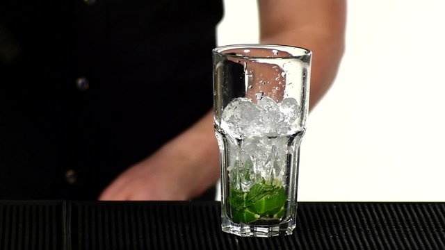 Bartender making and decorating cocktail. slow motion