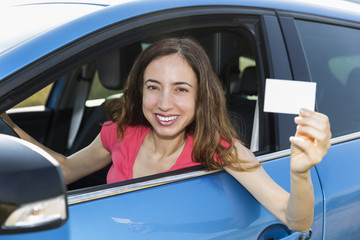 Woman driver showing sign card