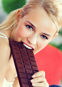 Happy Woman Eating Chocolate At Home