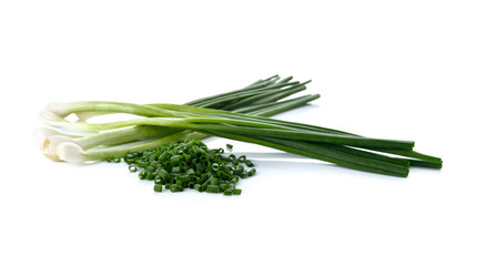 whole and sliced green spring onion on white background