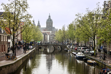 Fototapeta na wymiar Amsterdam Cathedral and canal street houses, Netherlands: