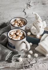 hot chocolate with marshmallows, ceramic Santa Claus, old book and gloves, bright wooden surface, vintage style