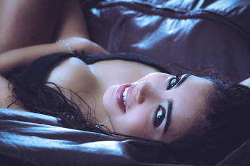 Sexy latina model lying in seductive position revealing some - obrazy, fototapety, plakaty