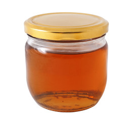 Closed jar of golden honey on white background