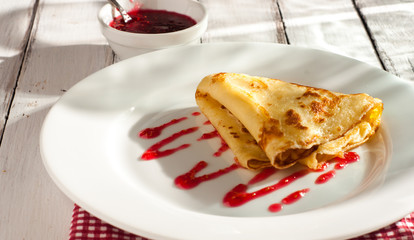 folded pancake on white plate