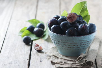 Red sweet figs on the wooden table