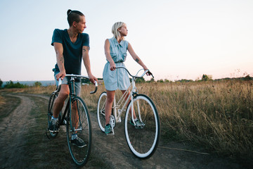 Obraz premium young couple on vintage bikes riding